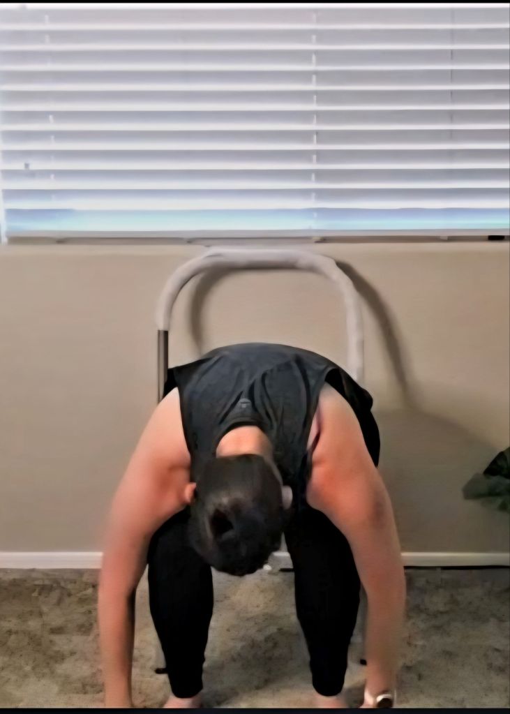 Woman folding forward over her legs in a seated chair yoga pose to release tension and calm the mind.